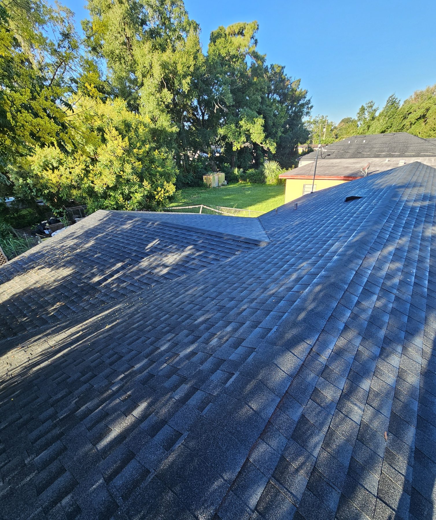 Shingle roof ridge line overlooking Central Florida neighborhood